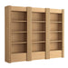 Angled view of Crate & Barrel Siena 102" Natural Wood 4-Shelf Storage Bookcase with Drawer, Set of 3 showing fluted details, four open shelves each, and bottom drawers