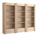 Angled view of Crate & Barrel Siena 102" Whitewash Wood 4-Shelf Storage Bookcase with Drawer, Set of 3 with fluted details, four open shelves each, and lower storage drawers
