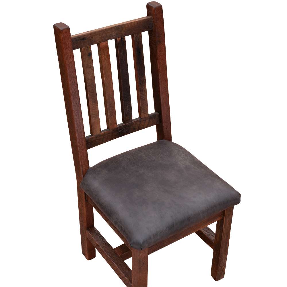 Angled view of Fireside Lodge Barnwood Prairie Dining Side Chair with a rustic wood frame, vertical slatted back, and dark cushioned seat