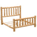 Angled view of Fireside Lodge Cedar Log Traditional Bed without a mattress highlights the open slat base, log posts, and evenly spaced vertical spindles on the headboard and footboard