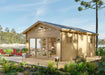 Angled back view of the Sawmill Structures Edwin Lake House PLUS 70MM Garden Room highlights its glass double doors, side windows, and a sunny natural setting by a lake