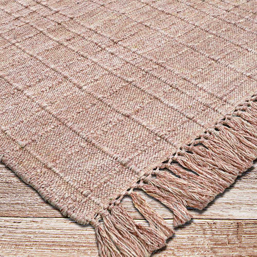 Angled from a corner, the Couristan Ascot Indoor/Outdoor Rug - Windowpane/Rose highlights its handwoven details and twisted fringes