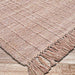 Angled from a corner, the Couristan Ascot Indoor/Outdoor Rug - Windowpane/Rose highlights its handwoven details and twisted fringes