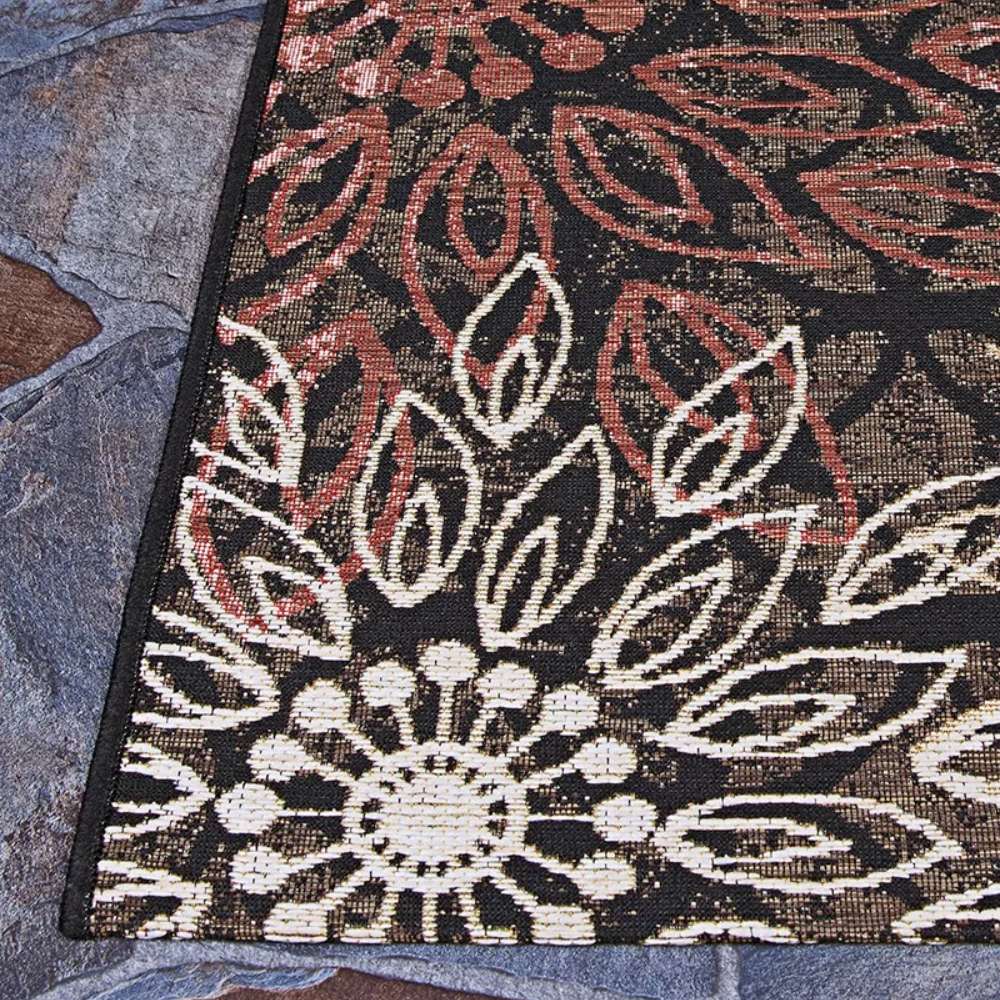 Another angle of Couristan Dolce Indoor/Outdoor Rug - Amalfi/Multi shows its crisp black edging and layered leaf motifs in soft neutral tones