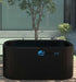 An outdoor Dreampod Ice Bath FLEX With Chiller setup beside a small tree and greenery