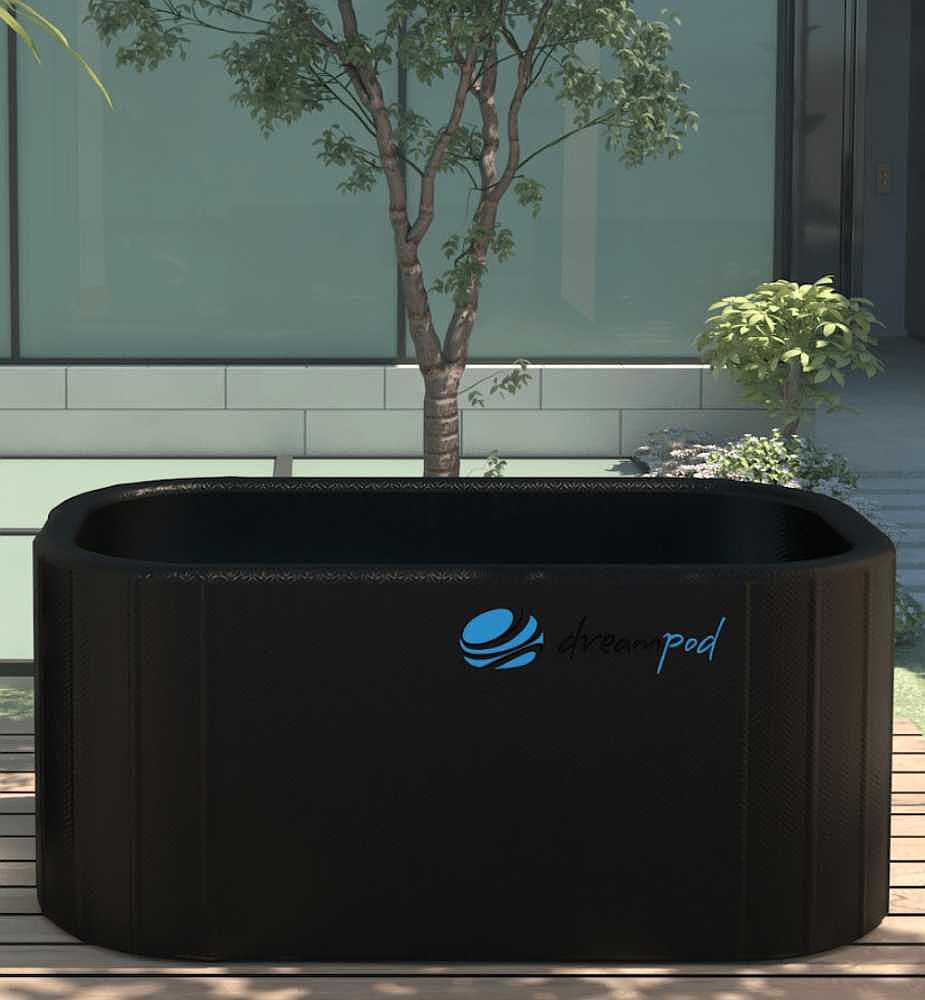 An outdoor Dreampod Ice Bath FLEX With Chiller setup beside a small tree and greenery