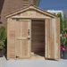 A partially opened Outdoor Living Today SpaceMaster 6×4 with Double Door shows one door open, revealing an empty wooden interior with sunlight casting inside