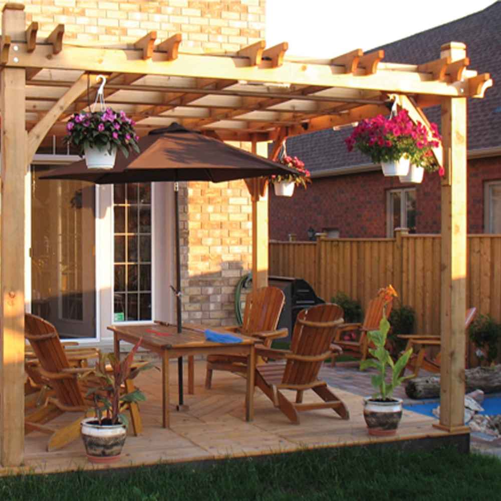 A patio scene featuring the Outdoor Living Today Western Red Cedar Pergola & Canopy with wooden chairs and hanging flower pots