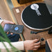 A person is adjusting the volume knob on Arkrocket Cassini Bluetooth Vinyl Turntable Record Player while using their phone to stream music via Bluetooth