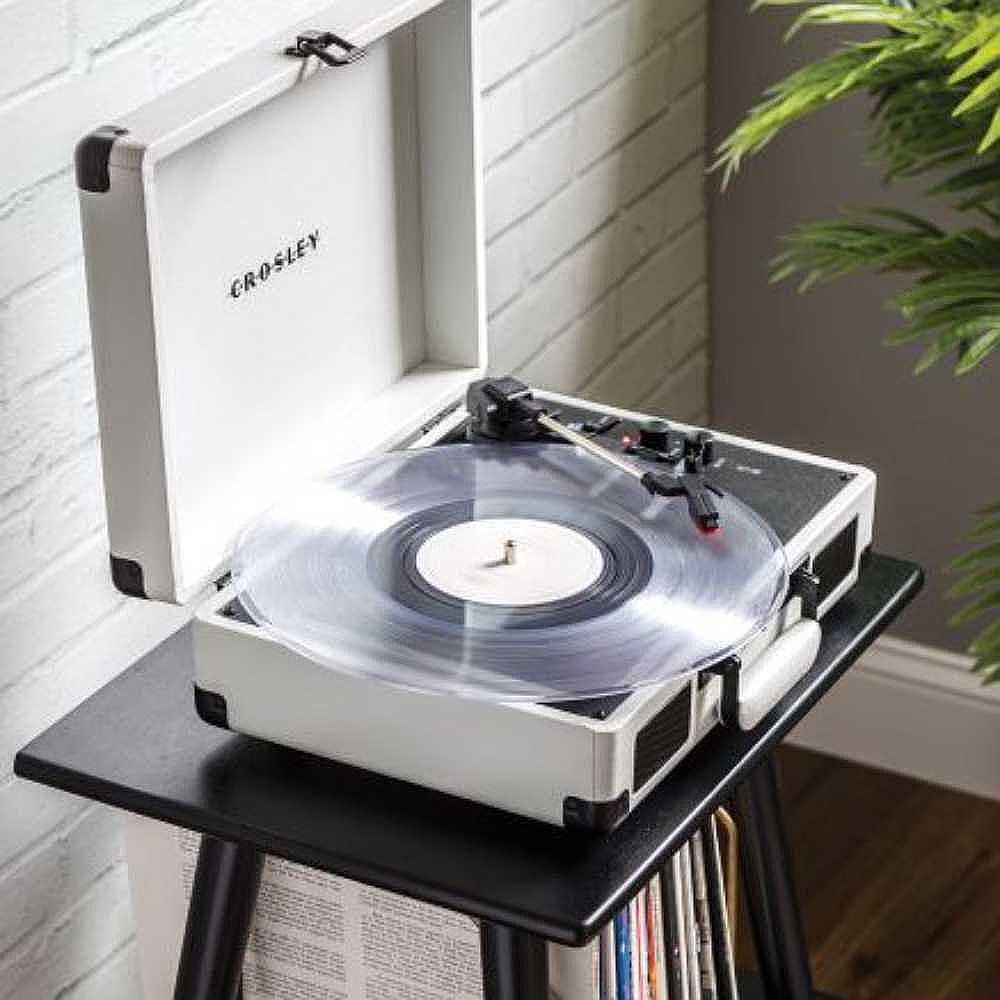 A perspective shot of the Crosley Cruiser Plus Portable Turntable with Bluetooth InOut - Exclusive White Farmhouse in a cozy indoor setup