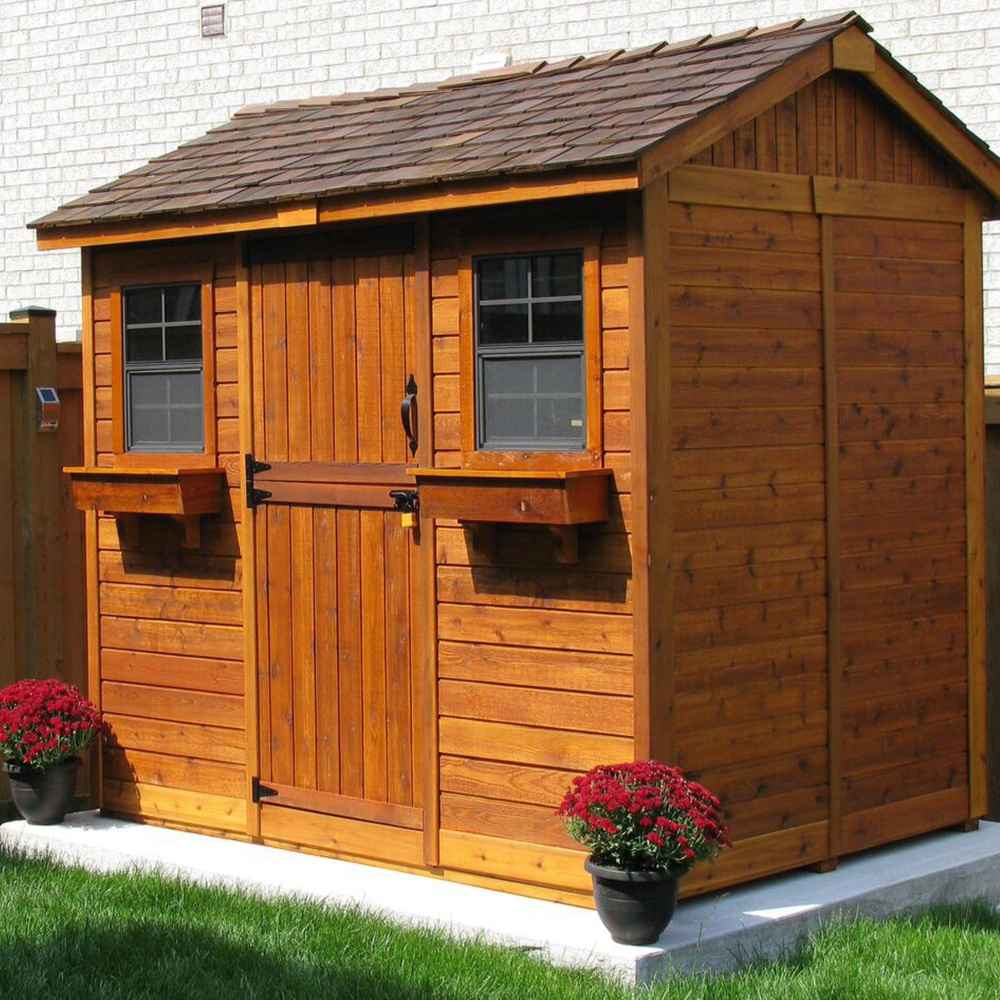 A rich cedar-colored shed with two windows and flower boxes sits on a concrete pad, showing the Outdoor Living Today 9×6 Cabana Garden Shed