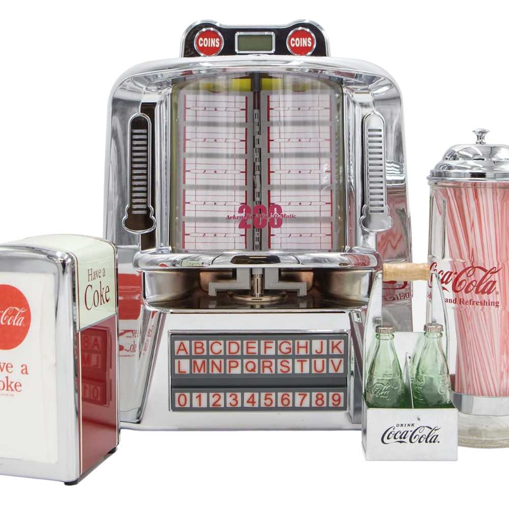 Arkrocket 200 Wall-O-Matic Table Jukebox Wallbox Bluetooth Speaker Radio in a retro diner setting surrounded by vintage Coca-Cola memorabilia