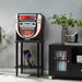 Arkrocket Boston Tabletop Jukebox Record Player Entertainment System with Stand is positioned in a stylish living space