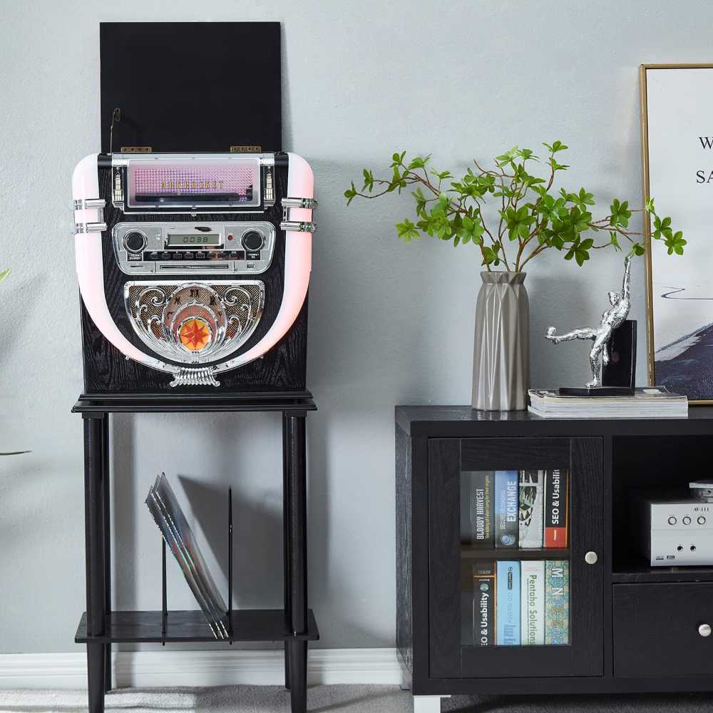 Arkrocket Boston Tabletop Jukebox Record Player Entertainment System with Stand is shown in a cozy living room setup