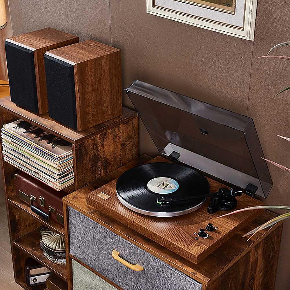 Arkrocket Cassini Bluetooth Vinyl Turntable Record Player 40 Watt Stereo Bookshelf Speakers is set up in a vintage-inspired room placed on a wooden cabinet