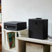 Arkrocket Coryphaeus Bluetooth Record Player with Record Storage Case (BlackGreen) is displayed on a shelf, with both the player and the storage case closed