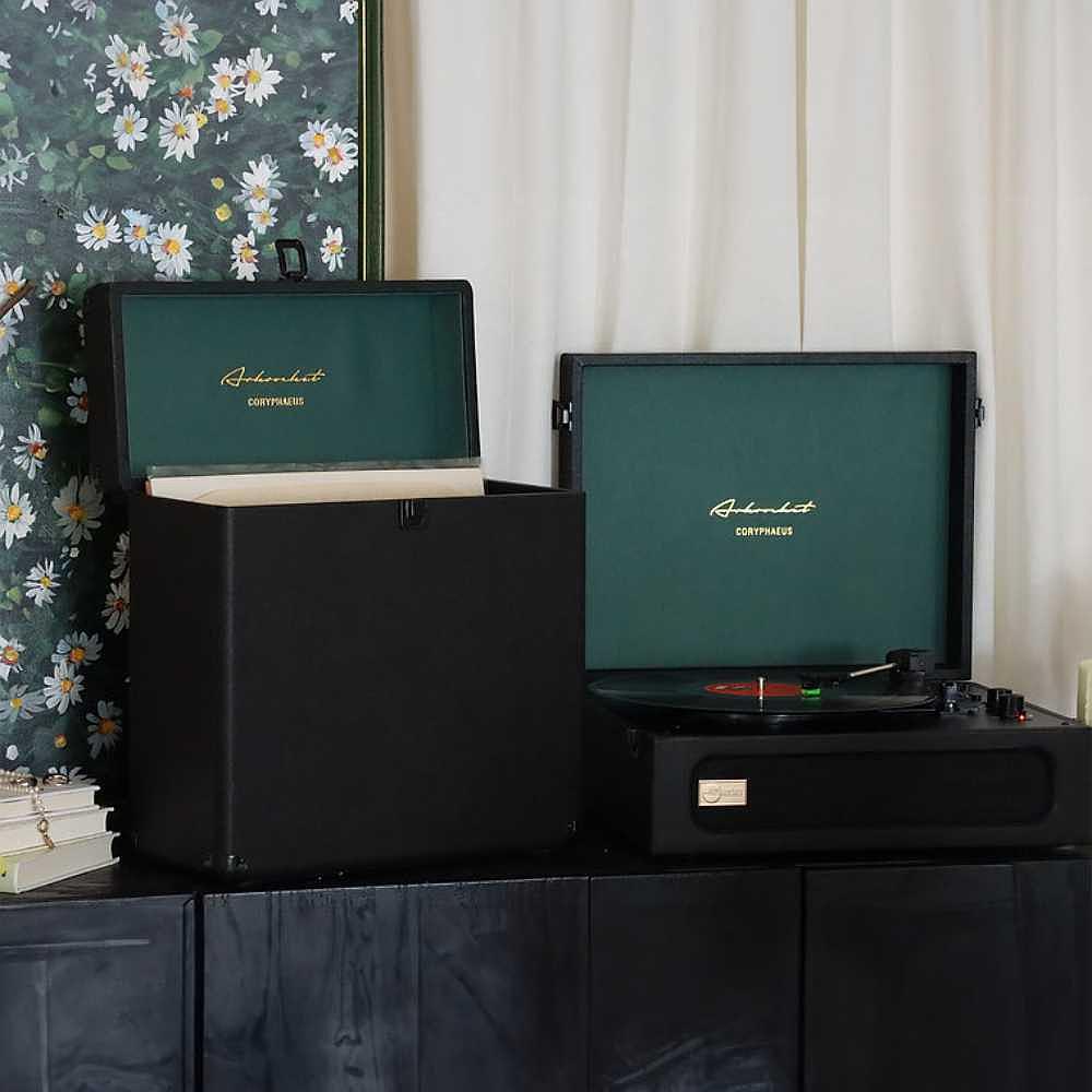 Arkrocket Coryphaeus Bluetooth Record Player with Record Storage Case (BlackGreen) is neatly set up on a cabinet with the storage case open next to it