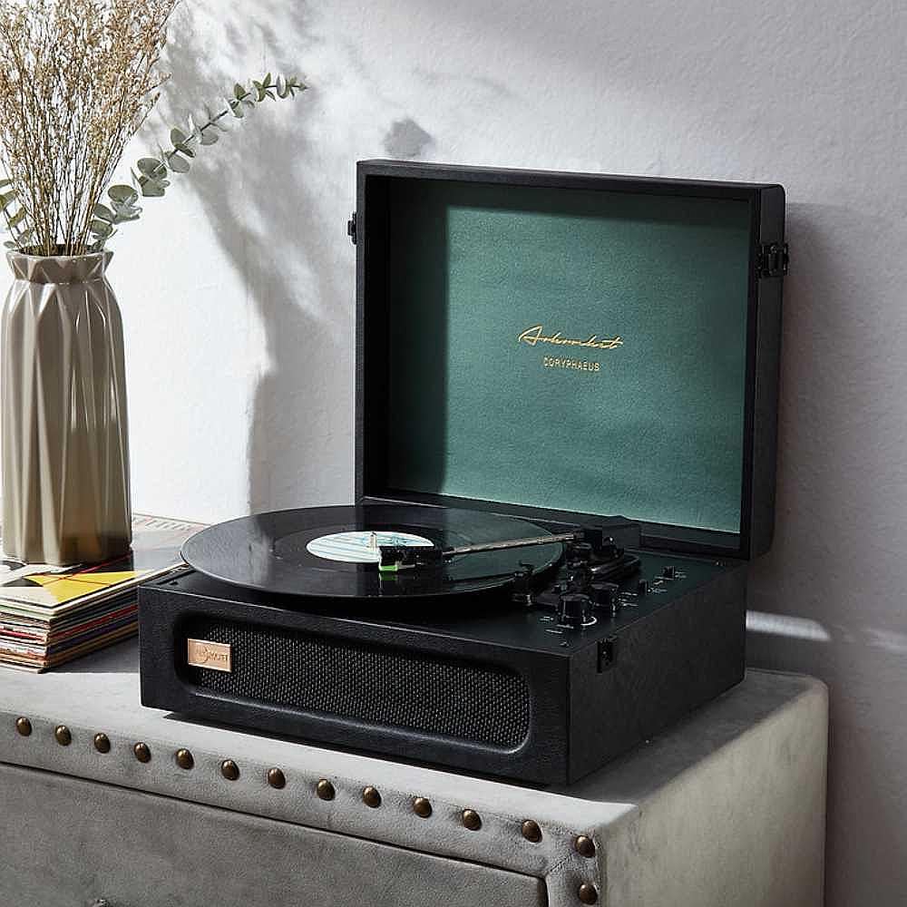 Arkrocket Coryphaeus Bluetooth Turntable Deluxe Edition Record Player (BlackGreen) is displayed open with a spinning record on a table next to a vase