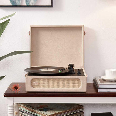 Arkrocket Coryphaeus Bluetooth Turntable Deluxe Edition Record Player (Flora Engraved) is displayed on a wooden table with an open lid and vinyl record playing