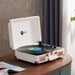 Arkrocket Curiosity Suitcase Bluetooth Turntable (Cream Rose Gold) playing a vinyl record on a wooden table