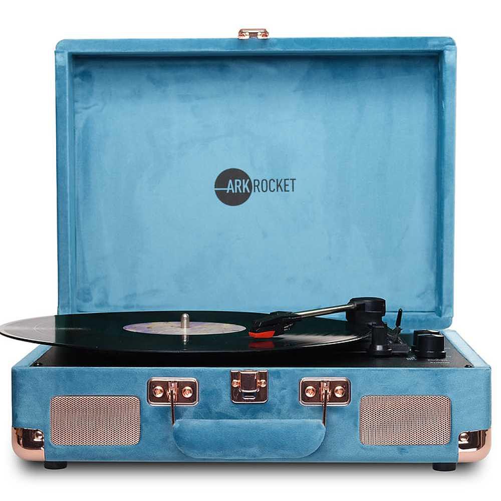 Arkrocket Curiosity Suitcase Bluetooth Turntable (Ocean Velvet) is shown open with a black vinyl record playing