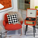 Arkrocket Discovery II Bluetooth Turntable Record Player With Legs (Orange) is placed near a cozy red chair