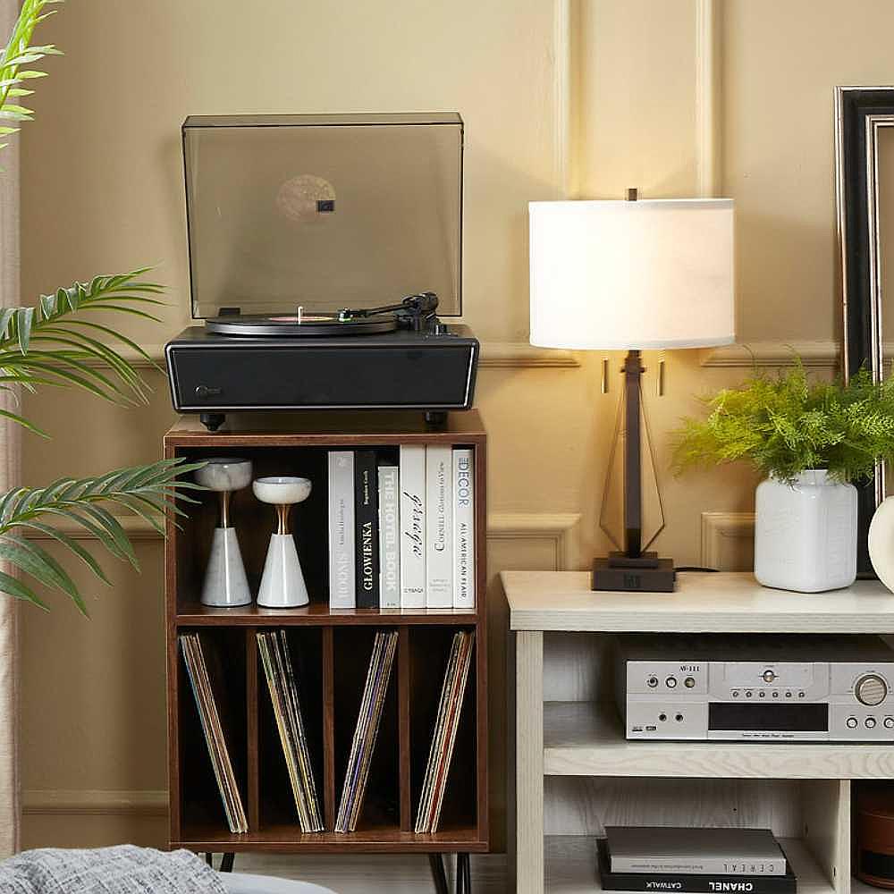 Arkrocket Huygens Bluetooth Turntable with Built-in Speakers (Black) on top of a wooden record cabinet with books and records underneath