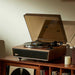 Arkrocket Huygens Bluetooth Turntable with Built-in Speakers (Walnut) on a wooden shelf playing a vinyl record with the dust cover open