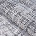 A rolled edge of the Couristan Charm Indoor/Outdoor Rug - Tiverton/Anthracite-Light Grey reveals its flexibility and fine texture