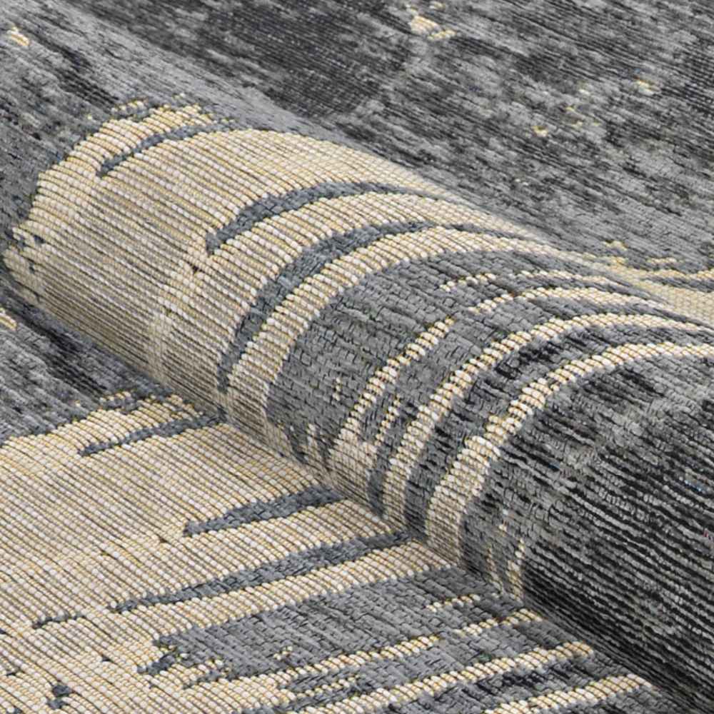 A rolled view of the Couristan Castille Indoor/Outdoor Rug - Canvas/Glacier displays its tightly woven structure and modern brushstroke design
