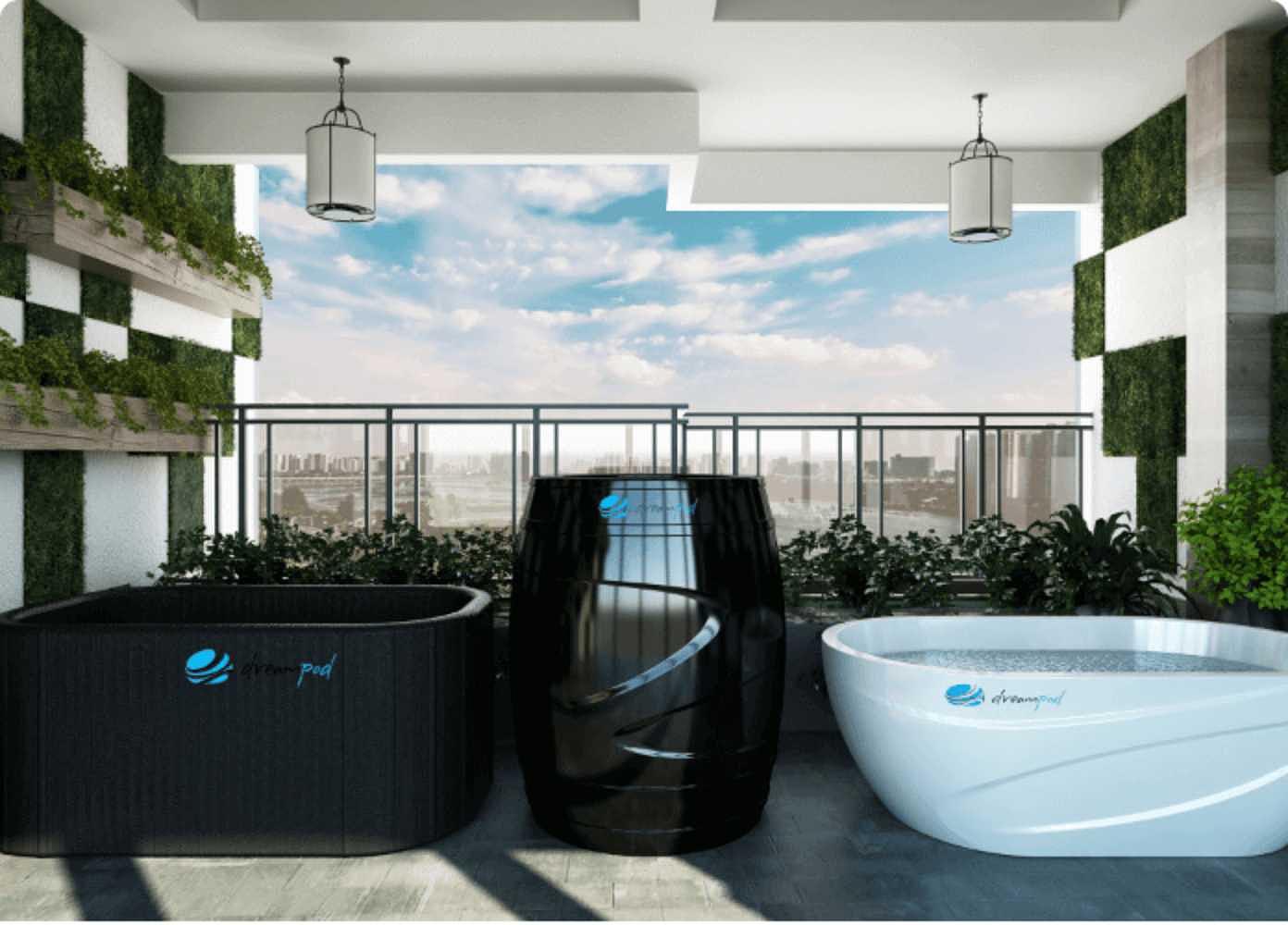 A rooftop setting with three Dreampod Cold Plunge Barrel FLEX with Chiller models in black and white, set against a cityscape view