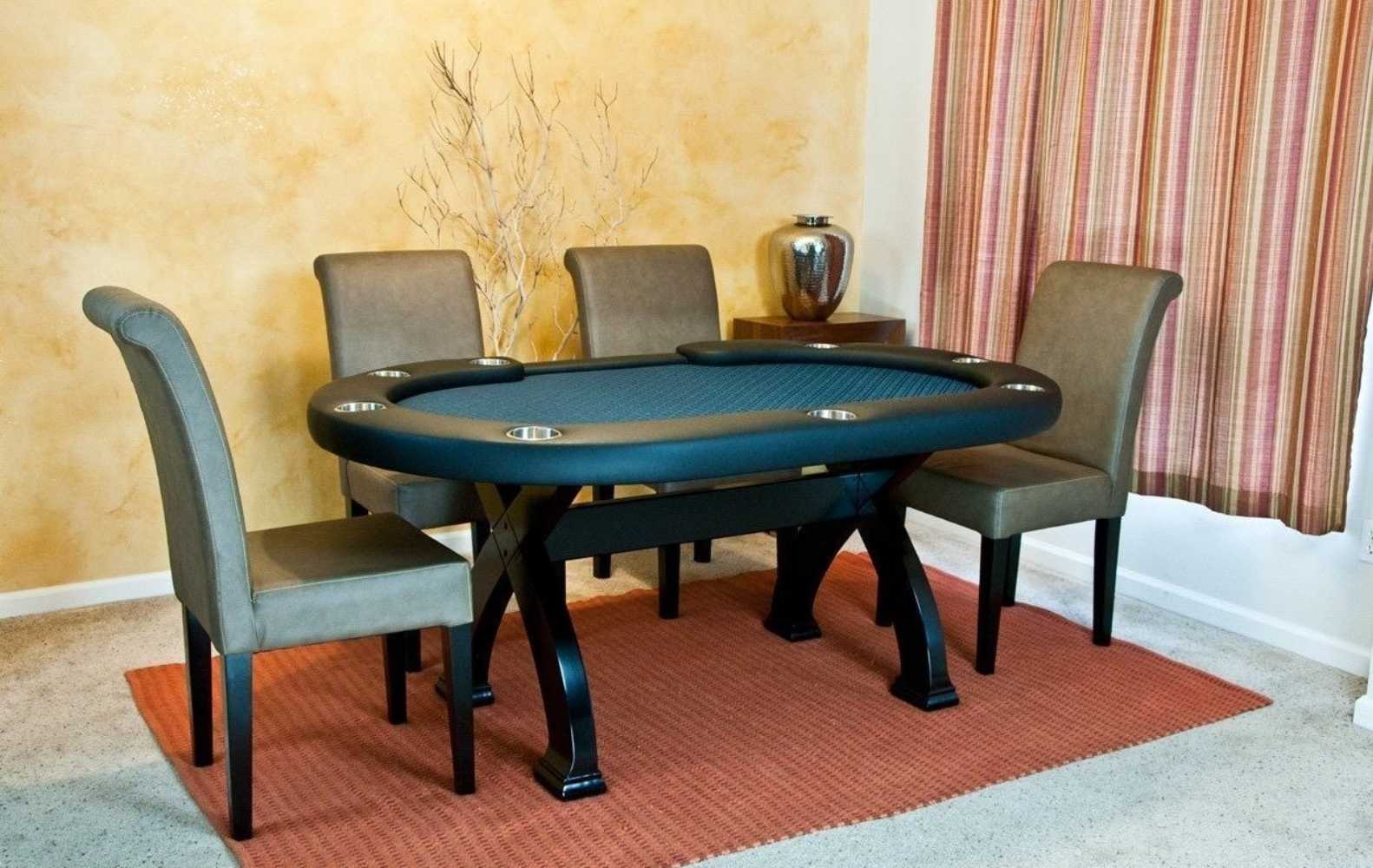 A room with four Coffee BBO Poker Tables Premium Lounge Chairs (Set of 2) around a black poker table with a blue playing surface