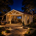 Lighted wood studio with glass doors and stone path at night. People sit inside the ALU Concept Arosa 44A Freedom Office.