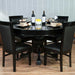 A round dining table topped with BBO Poker Tables Black Round Dining Top (Nighthawk/Ginza) and four chairs arranged for a stylish meal setup