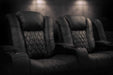 A row of onyx Valencia Tuscany XL Luxury Edition Home Theater Seating in a dimly lit home theater