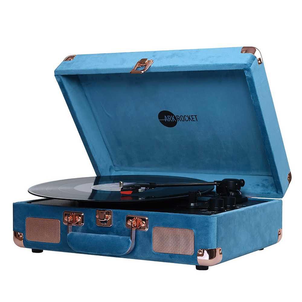 A side-angle view of Arkrocket Curiosity Suitcase Bluetooth Turntable (Ocean Velvet) with a black vinyl record playing and the turntable lid propped open