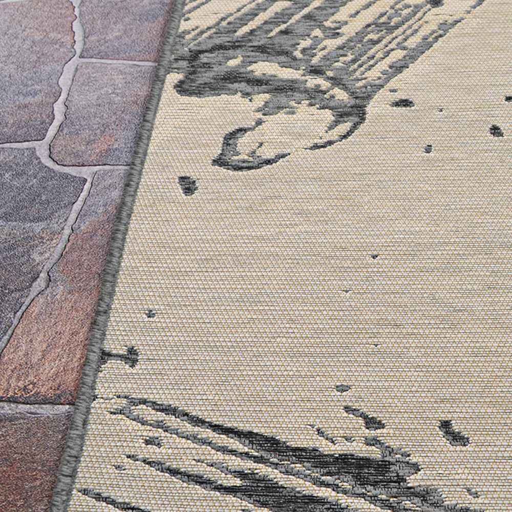 A side angle of the Couristan Castille Indoor/Outdoor Rug - Canvas/Glacier shows its clean edge against stone flooring