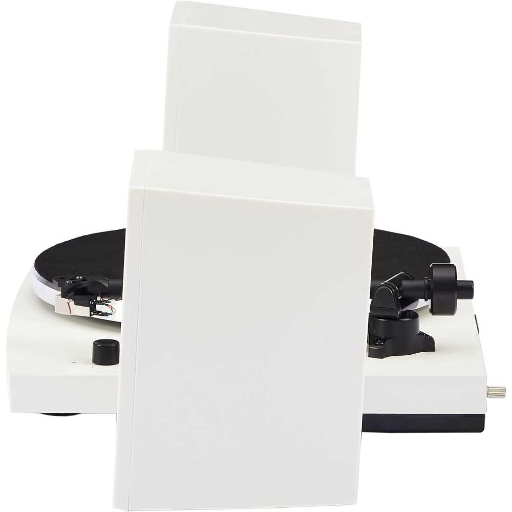 A side angle of the Crosley T150 T-Series Turntable System - White with both white speakers stacked together beside the turntable