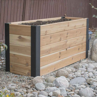 A side view displays the Outdoor Living Today 4×1.5 Urban Raised Garden Bed with soil inside and rocks surrounding its base