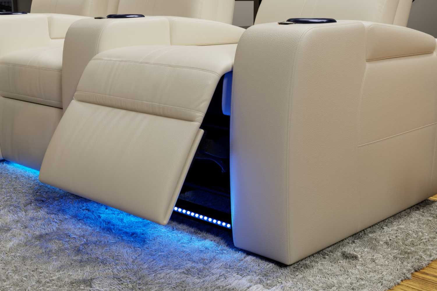 A side view of Valencia Natalie Home Theater Seating showcases the extended footrest with a glowing blue LED base