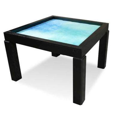 A sleek onyx black Game Theory Tables Origins Modular TMC Game Table with a light blue playing surface