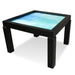 A sleek onyx black Game Theory Tables Origins Modular TMC Game Table with a light blue playing surface