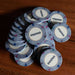 A stack of light gray BBO Poker Tables 500-Piece Classic Casino Poker Chips, each marked with a $10,000 denomination