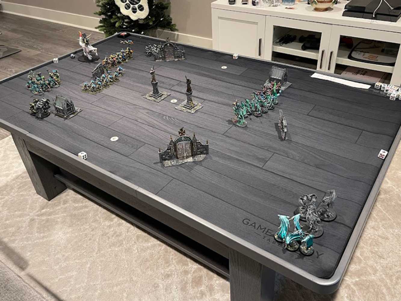 A strategic tabletop war game with miniatures set up on the Game Theory Tables The Origins Coffee Table