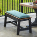 A sturdy black and wood-tone bench is topped with a comfortable teal LuxCraft 41 Cafe Bench Cushion