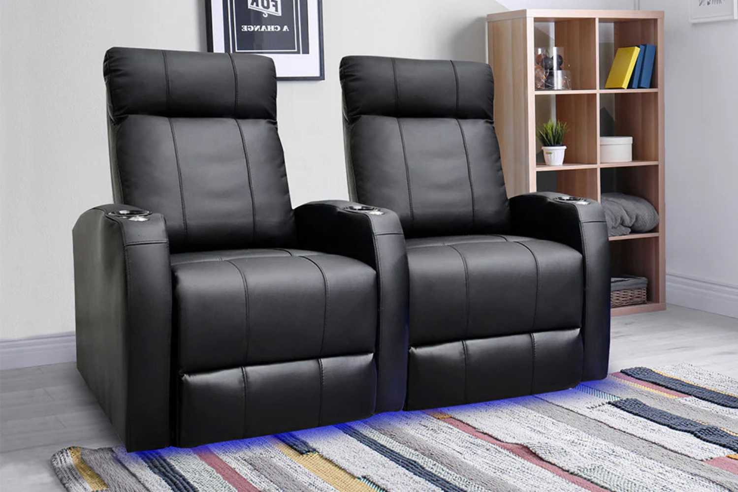 A stylish lifestyle image shows two Valencia Syracuse Home Theater Seating chairs side by side in a modern room