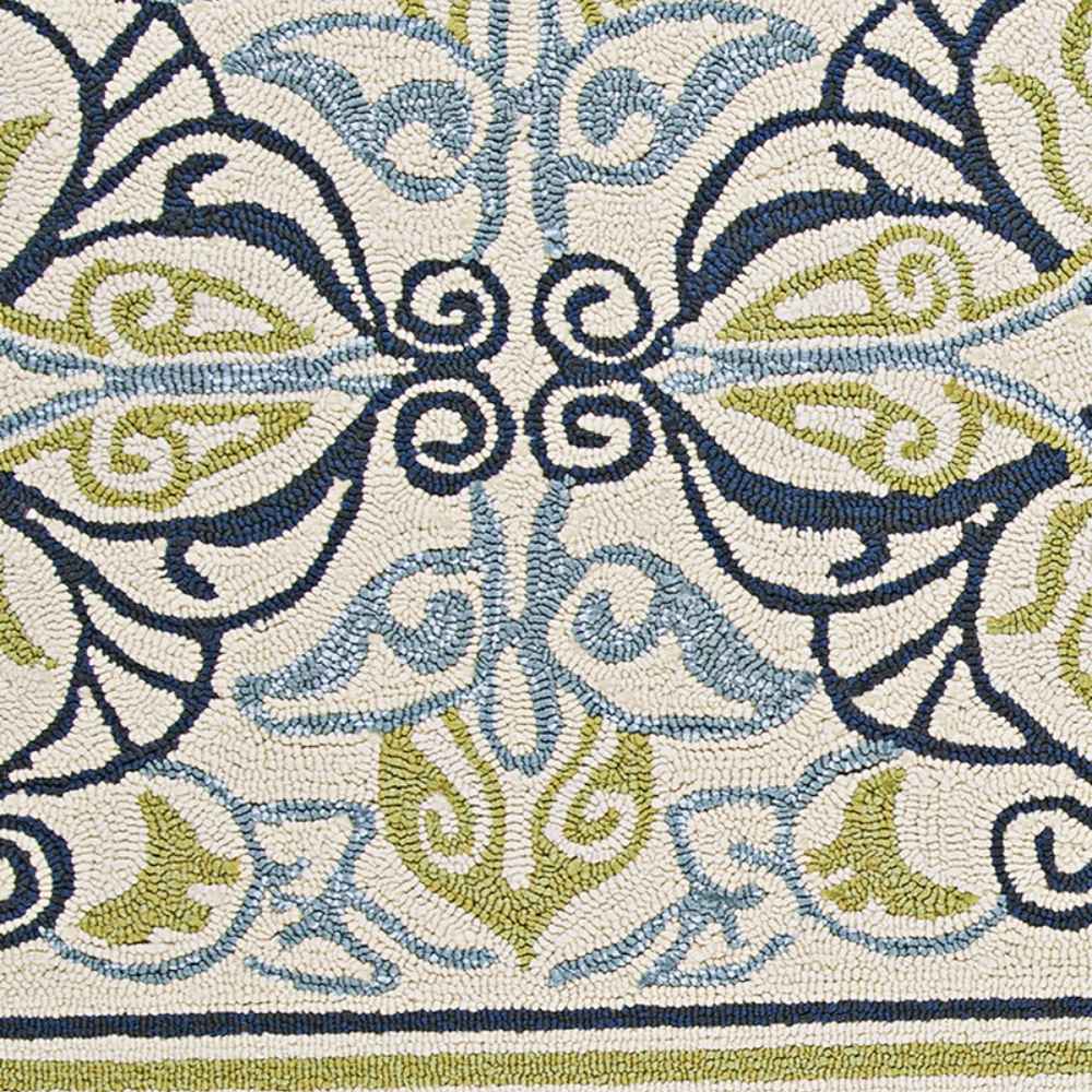 A symmetrical section of the Couristan Covington Indoor/Outdoor Rug - Pegasus/Ivory-Navy-Lime features swirls and leaves in navy, slate blue, and lime