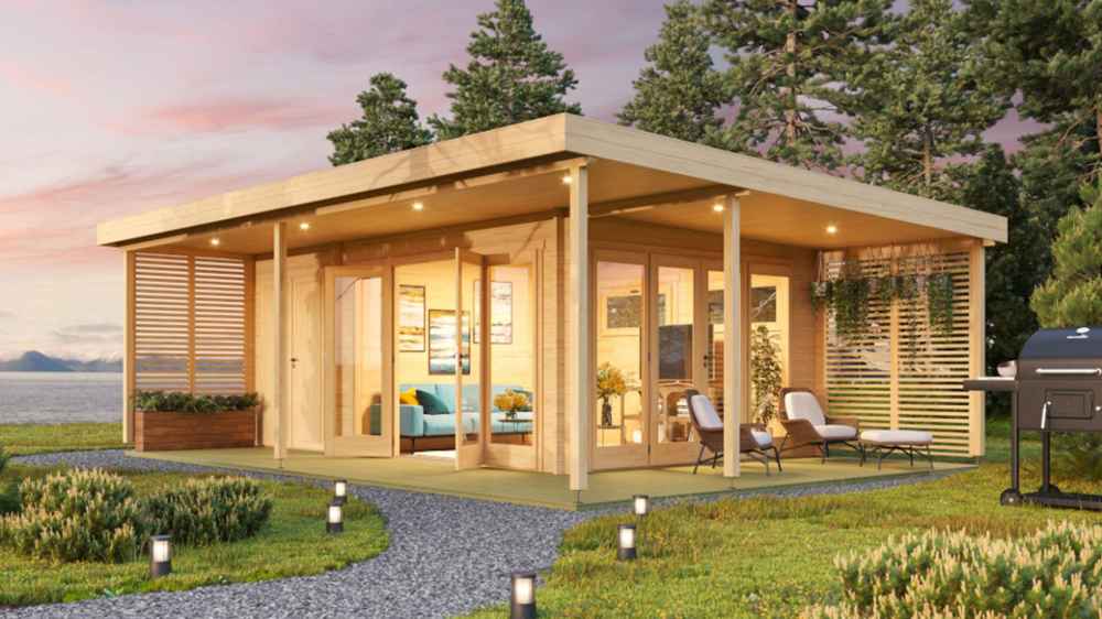 At sunset, the GardenHouse24 USA Kilian 70 Garden Room glows with ambient lighting, outdoor seating, and a cozy furnished interior