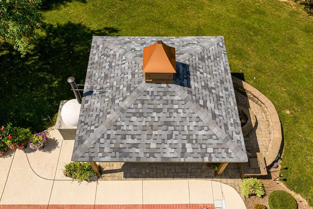 A top-down aerial view of the Brookside Timber Frame Forest Melody Pavilion, showcasing its durable shingled roof