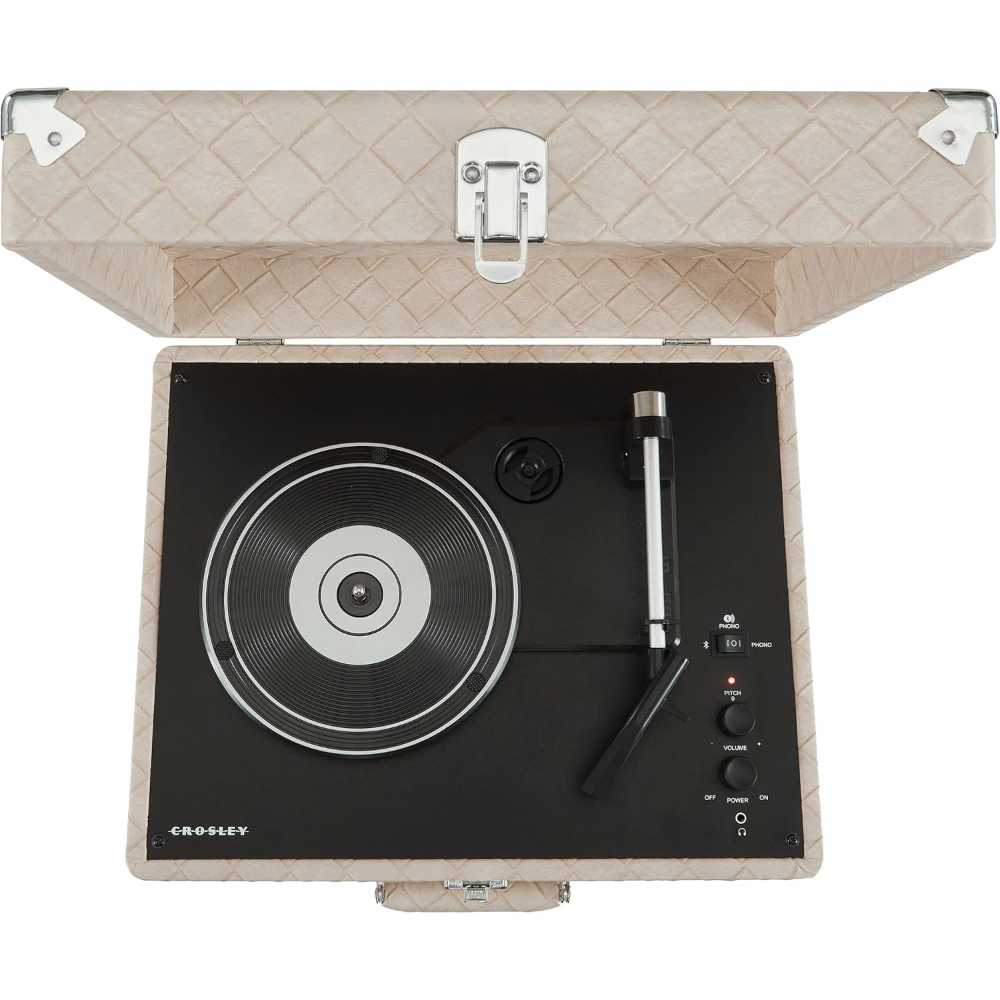 A top-down view shows the Crosley Anthology Portable Turntable - Light Tan with its textured case open, revealing the vinyl platter and control knobs